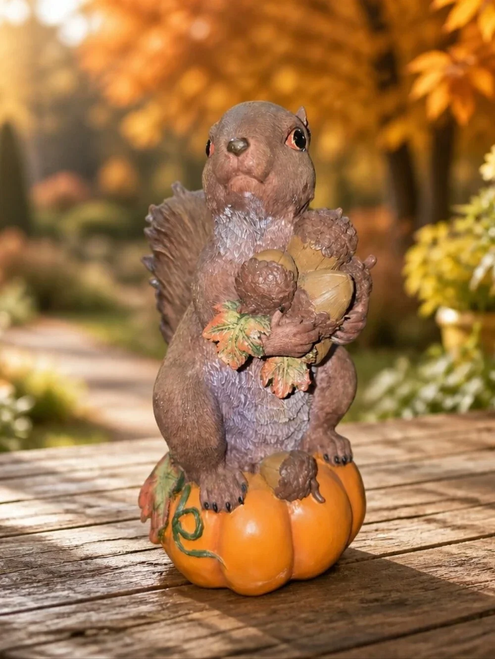 vintage resin autumn squirrel figurine perched atop a pumpkin Holdinging Nuts